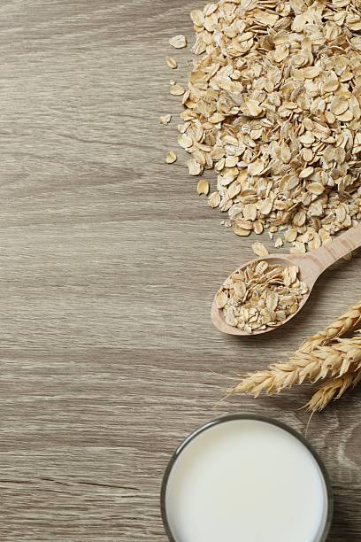 istock Composition with oatmeal flakes on gray background. Cooking breakfast 2253183361