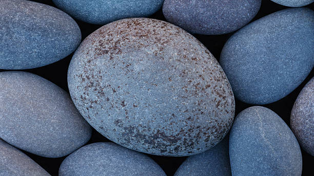 istock Pebbles stones on seashore as  texture background for design web banner template page. SPA concept background 2253183381