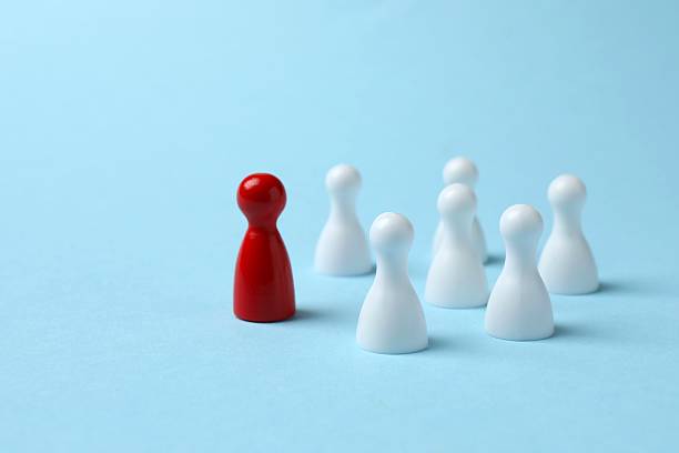 istock Group of colored pawns on the table. Concept of unity 2253184155
