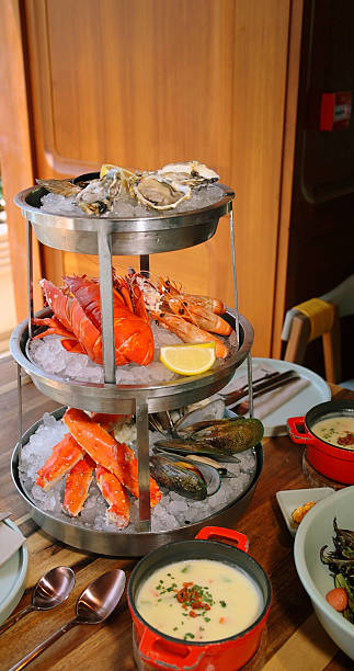 Luxury seafood platter on ice in restaurant setting features oysters,