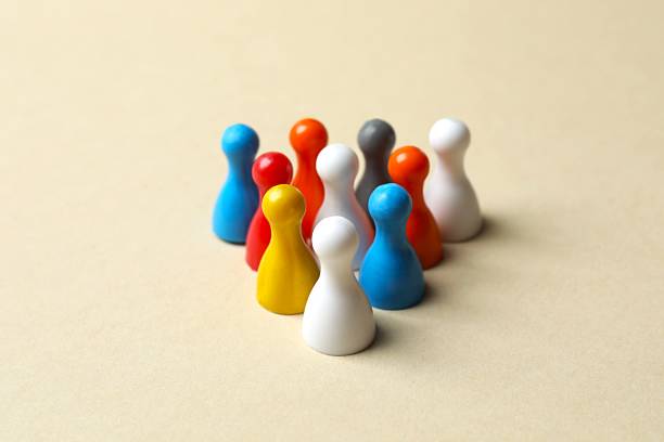 istock Group of colored pawns on the table. Concept of unity 2253184170