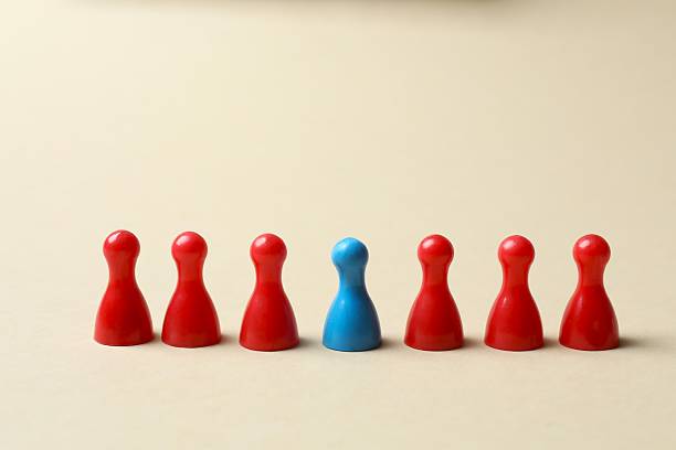 istock Group of colored pawns on the table. Concept of unity 2253184174