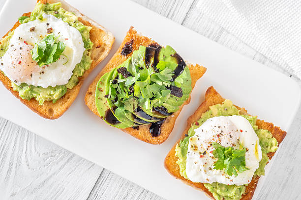istock Ciabatta sandwiches with poached egg, avocado mash, sundried tomato and herbs 2253184321