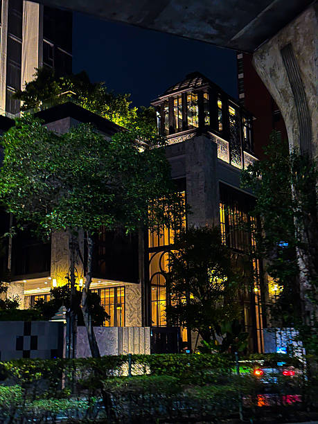 Illuminated Modern Glass Building Night View Under Concrete Overpass