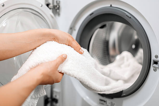 istock White laundry is removed from the washing machine 2253185431