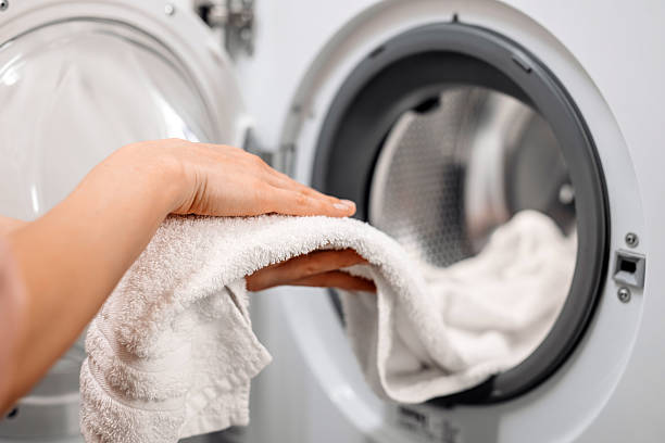 istock White laundry is removed from the washing machine 2253185433
