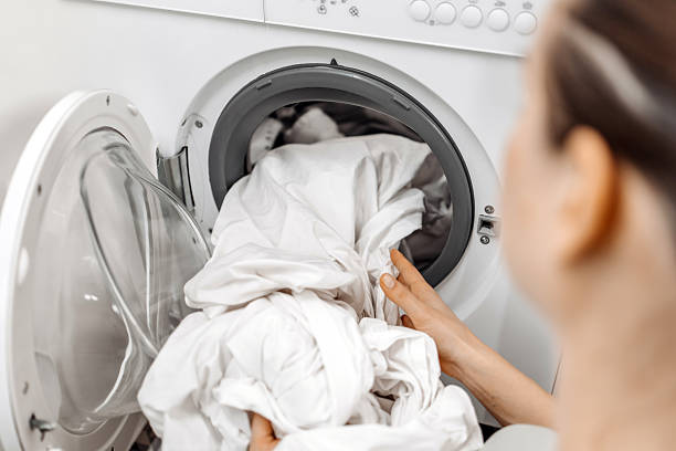 istock White laundry is removed from the washing machine 2253185521