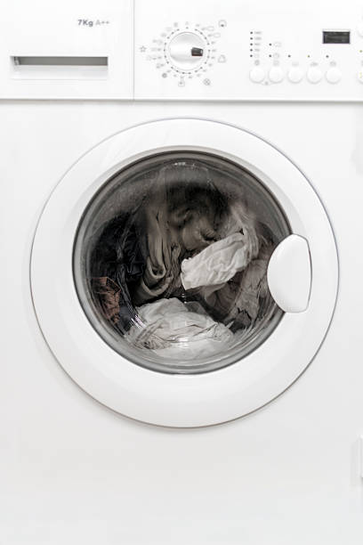 istock Washing machine with transparent door showcasing white laundry inside 2253185574
