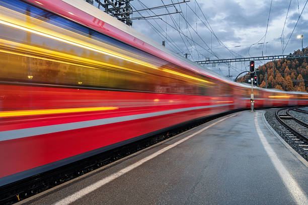 istock Blurred red passenger train passing mountain railway station 2253186666