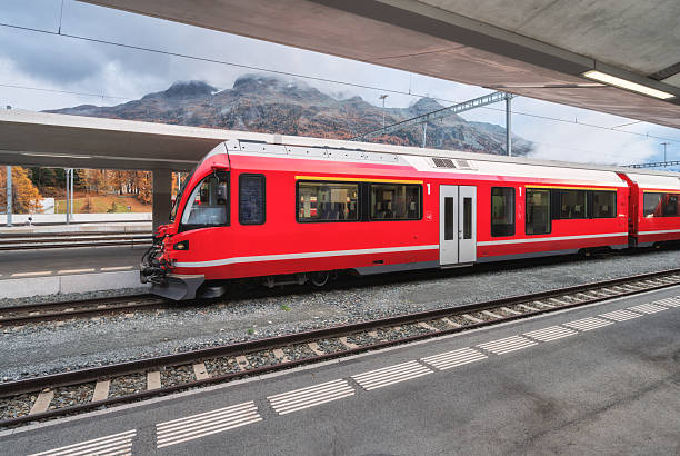 istock Red modern passenger train on mountain railway station in Alps 2253186670