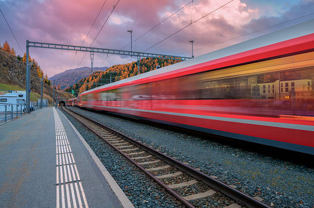 istock Blurred red passenger train passing mountain railway station 2253186671