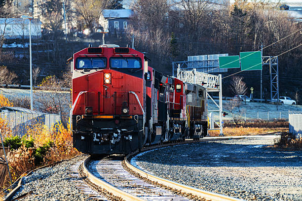 A trio of diesel locomotives nearing a railyard.