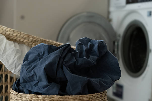 istock Laundry baskets with dirty laundry near the washing machine 2253189419