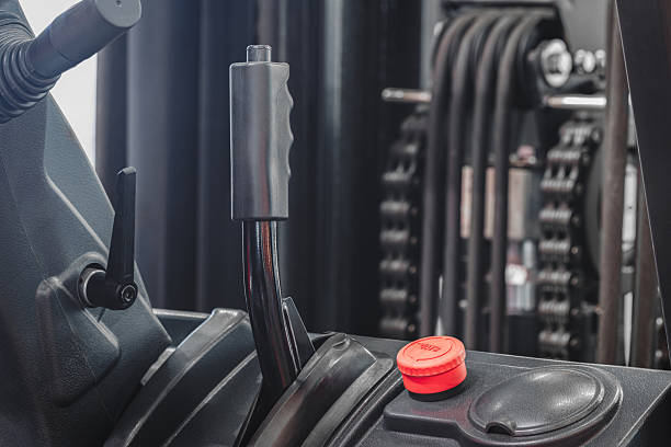 istock Forklift with a red button on the steering wheel. The forklift is parked in a warehouse 2253190930