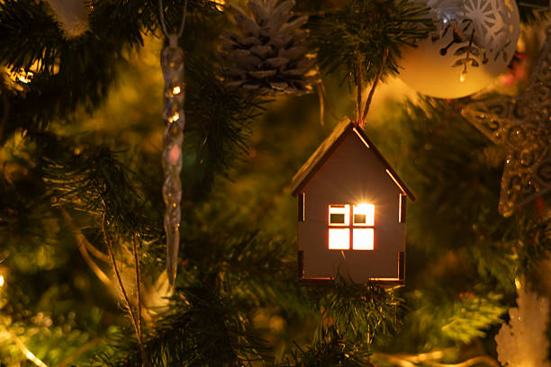 istock A small wooden house on a Christmas tree 2253191435