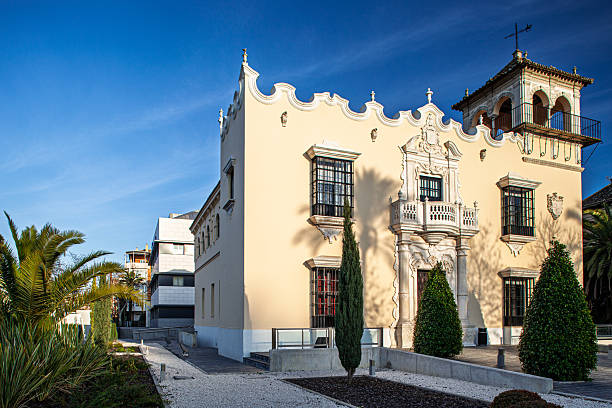 Architectural daytime exterior view capturing House for Urcola's Widow in Seville, Spain, designed by Romualdo Jimenez Caldes in 1935. Neobarroque style.