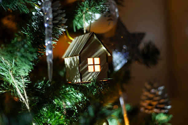istock A small wooden house on a Christmas tree 2253191544