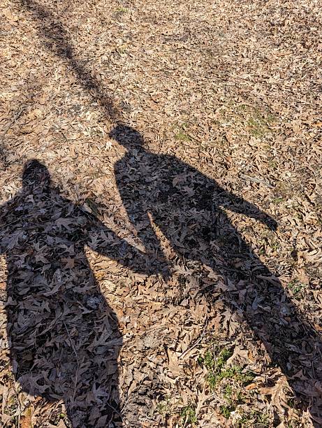 istock Shadows holding hands in the woods 2253191642