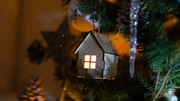 istock A small wooden house on a Christmas tree 2253191796