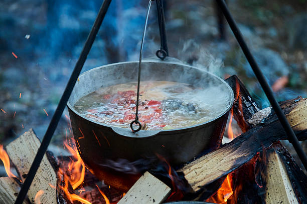 istock Cooking fish soup in the stowed bowler over a campfire. 2253191903