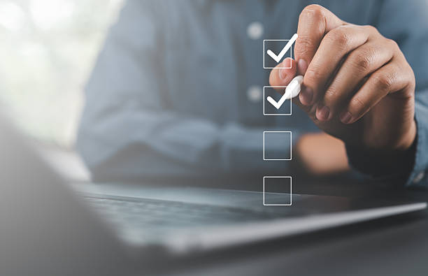istock Businessman use pen to tick correct sign mark in checkbox for quality document control checklist and business approve project concept. 2253192052