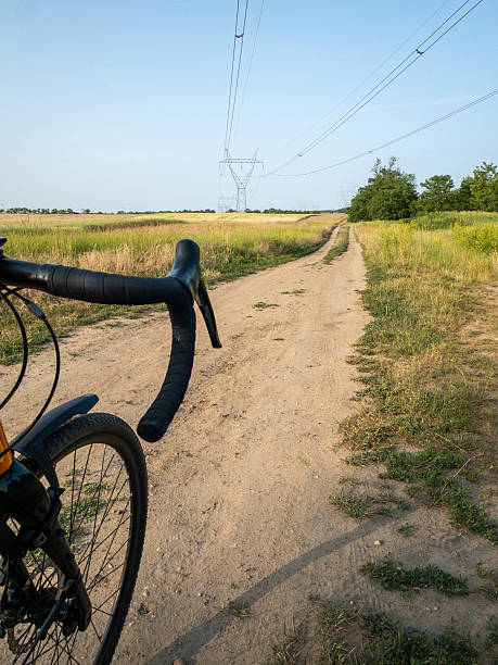istock gravel bike on dirt path through rural fields 2253192427