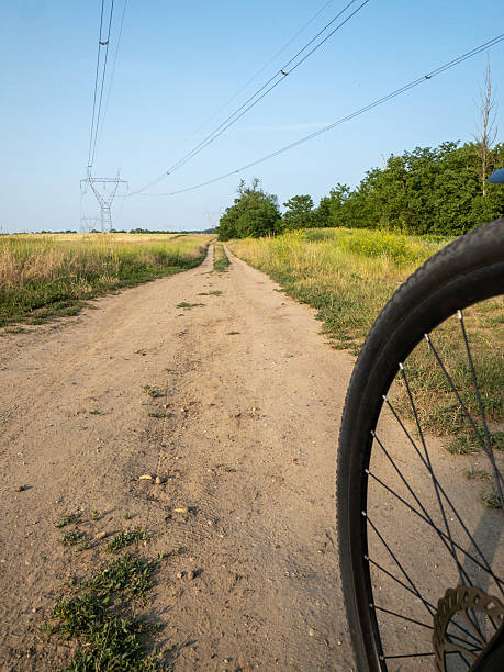 istock bicycle wheel on dirt road in rural landscape 2253192428