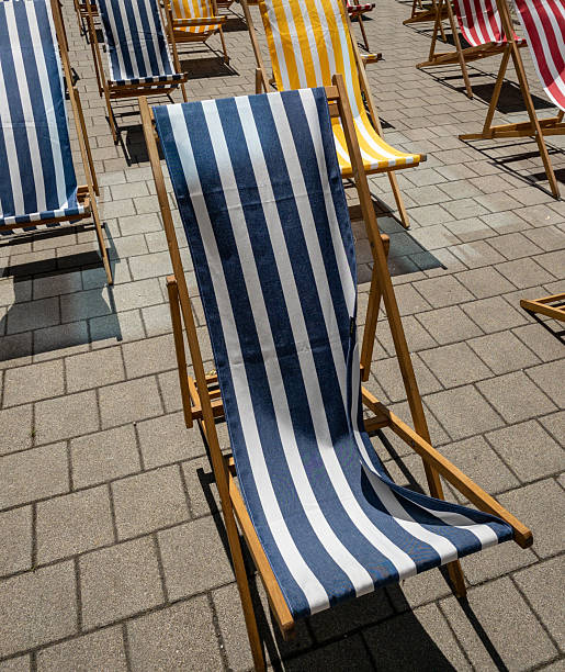 istock blue white striped deck chair in sunlight 2253192453