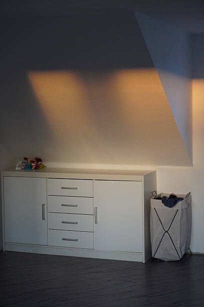 istock Minimalist Attic Interior with White Cabinet and Soft Light 2253193649