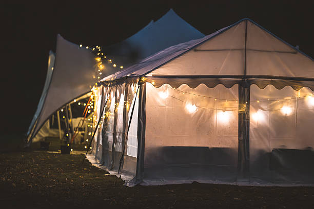 istock Outdoor event tent illuminated with string lights at night 2253193868