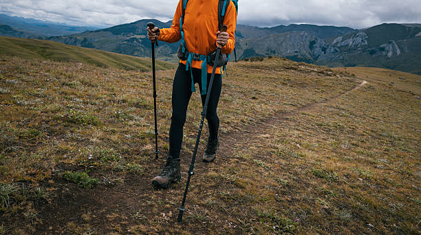 istock Woman backpacker hiking on high altitude mountains top 2253194726
