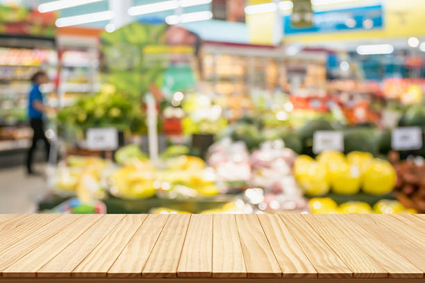 istock Empty wood table top with supermarket blurred background for product display 2253195203