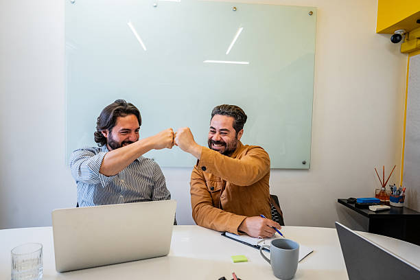istock Coworkers doing fist bump on the office 2253197640