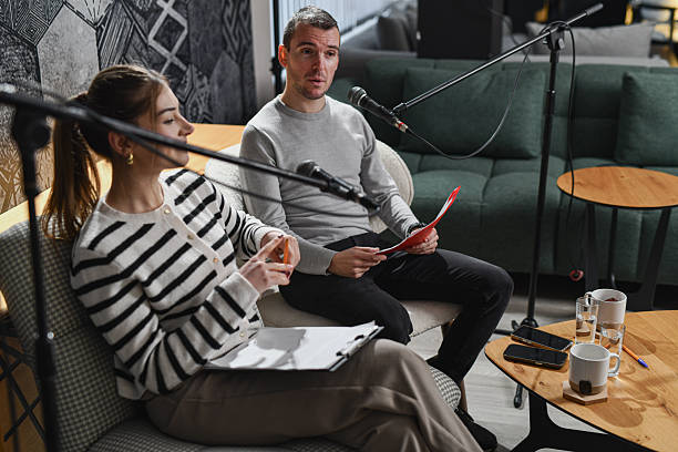 istock Podcast Interview With Female Host And Male Guest In Studio 2253199678