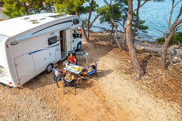 Modern RV Travelers Enjoy Outdoor Dining By Clear Blue Adriatic Waters