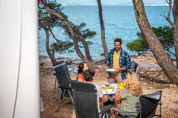 istock Multicultural Friends Enjoying Morning Meal By Seaside Motor Home Camping 2253201049