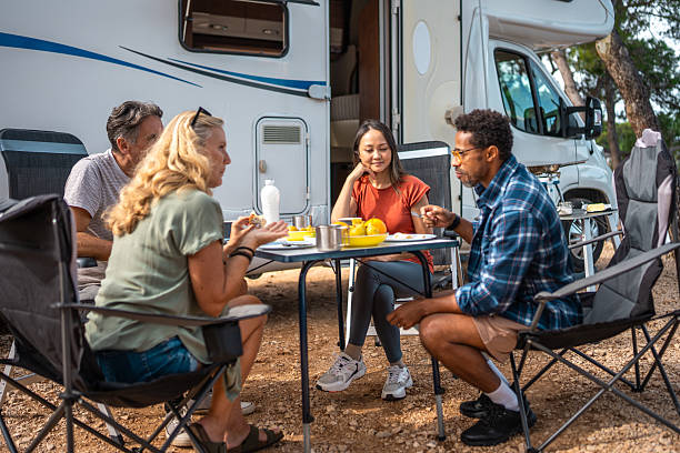 istock Multicultural Couples Gather For Casual Breakfast Near Parked Motor Home 2253201055