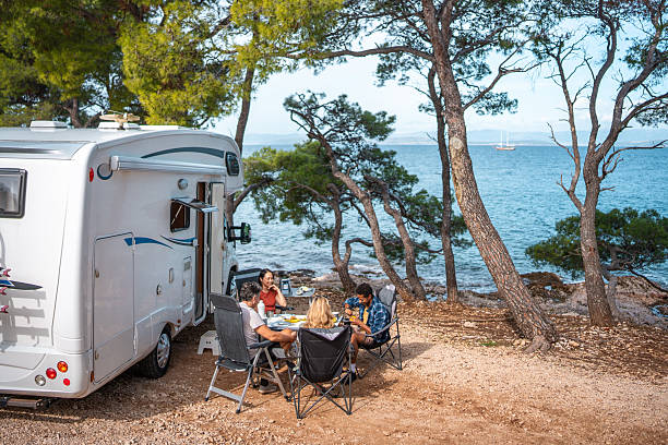 istock Relaxed Group Enjoys Casual Breakfast By Seaside Motor Home Camping 2253201069