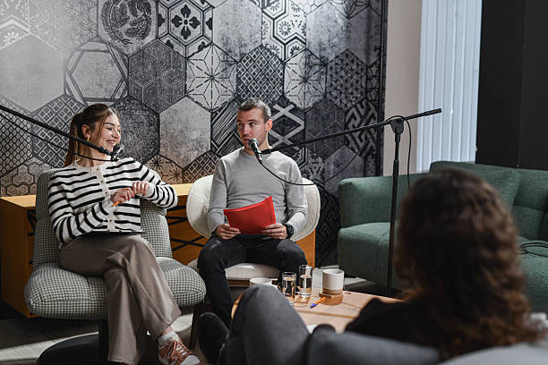 istock Hosts Interviewing Guest On Casual Studio Set During A Live Talk Show Recording 2253201547