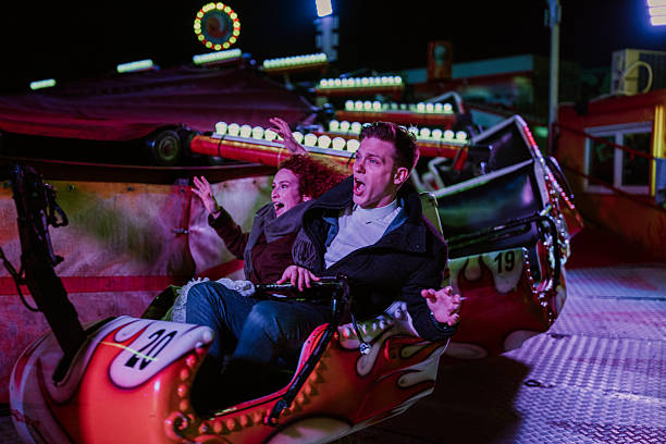 istock Couple screaming on fairground ride at night 2253203416