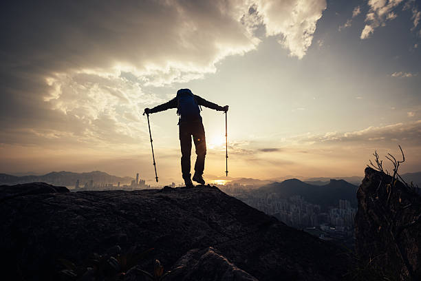 istock Successful backpacker enjoy the view stand on the cliff edge in hong kong 2253203464