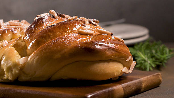 istock Glossy Sweet Braided Bread with Sliced Almonds and Powdered Sugar 2253203991