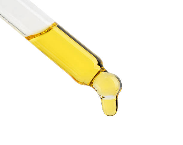 istock Dripping tincture from pipette isolated on white 2253207813