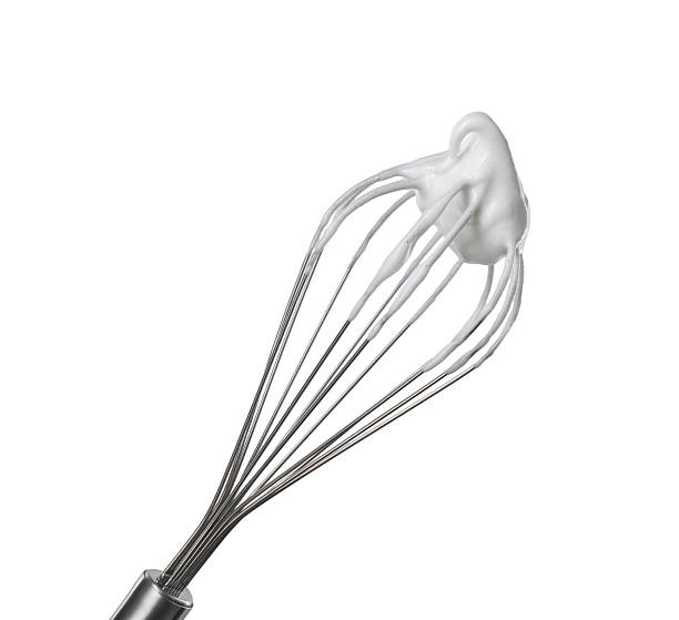 istock Whisk with whipped egg whites isolated on white 2253208925