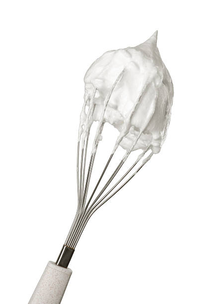 istock Whisk with whipped egg whites isolated on white 2253208990