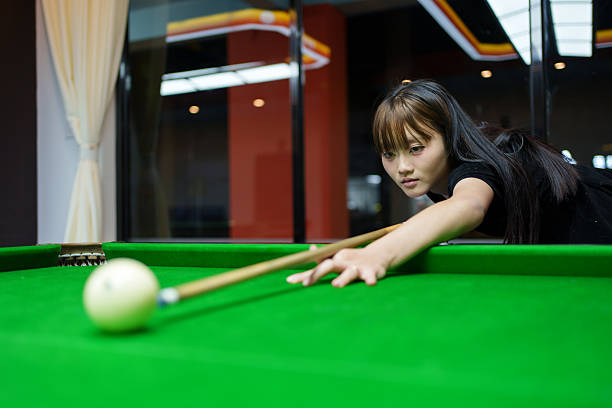 istock A young Asian man is concentrating on playing billiards. 2253214943