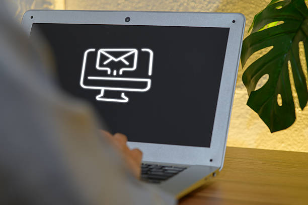 A sleek laptop with a minimalistic email icon symbolizes digital marketing strategy. The modern workspace reflects innovation and communication in business essentials.