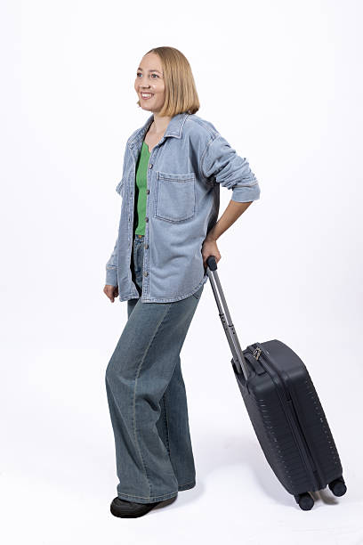 istock Woman in casual clothes walking with a suitcase. 2253220469