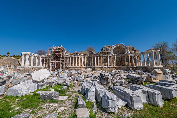 Side, Turkey, March 14 2025, View of an active archaeological excavation site with ancient ruins, marble blocks and scaffolding in Side.