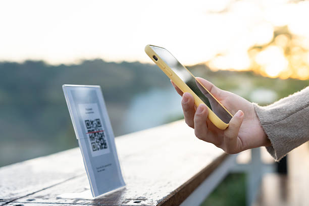 istock Woman use smartphone to scan QR code for order menu in cafe restaurant with a digital delivery. Choose menu and order accumulate discount. E wallet, technology, pay online, credit card, bank app. 2253223124